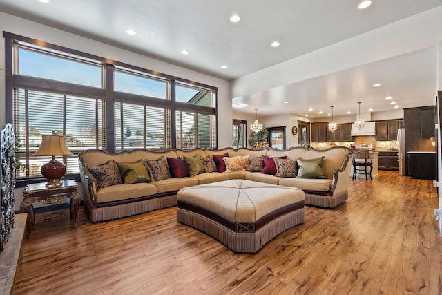 living room featuring light hardwood / wood-style floors and an inviting chandelier