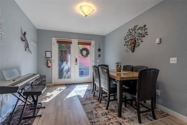 dining area with french doors and light wood-type flooring