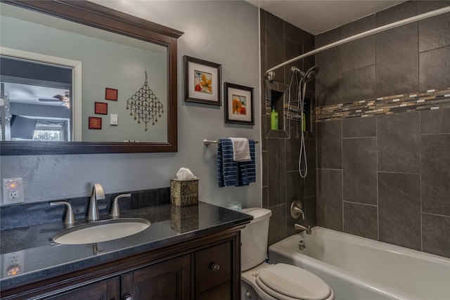 full bathroom with toilet, tiled shower / bath, and vanity