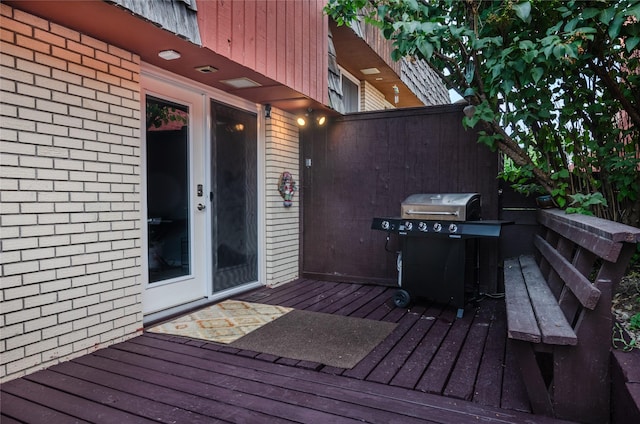 wooden deck with a grill