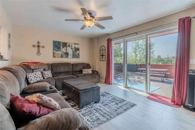 living room with ceiling fan and light hardwood / wood-style floors