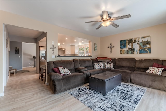 living room featuring ceiling fan and hardwood / wood-style flooring