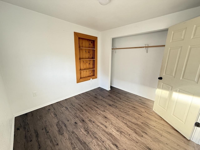 unfurnished bedroom featuring hardwood / wood-style flooring and a closet