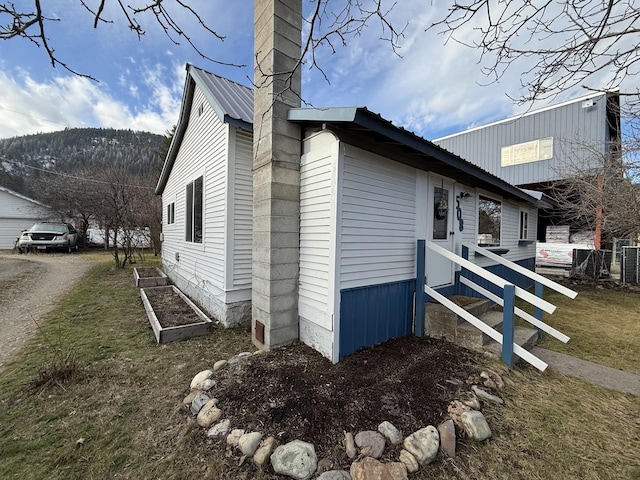 view of side of home with a lawn