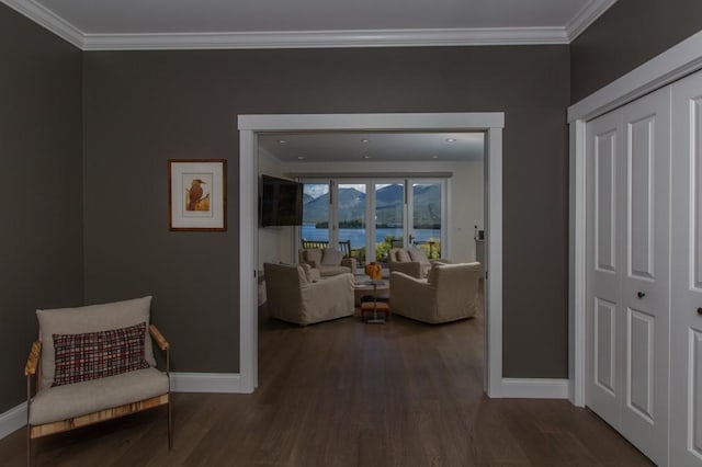 hall featuring dark hardwood / wood-style floors and crown molding