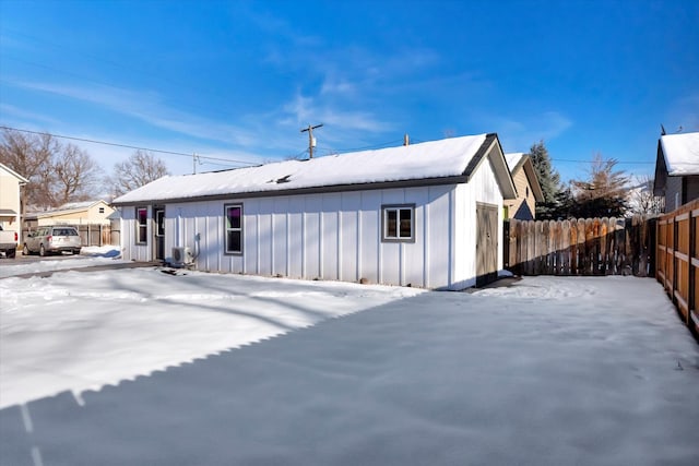 view of snow covered rear of property