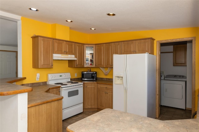 kitchen with vaulted ceiling, washer / clothes dryer, kitchen peninsula, light tile patterned flooring, and white appliances