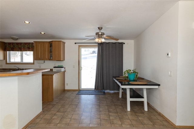 kitchen featuring ceiling fan and kitchen peninsula