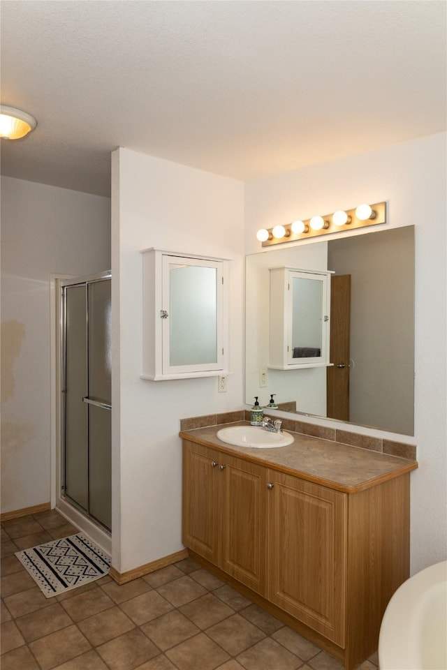 bathroom featuring vanity, tile patterned floors, and an enclosed shower