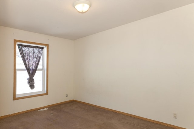 spare room featuring carpet floors