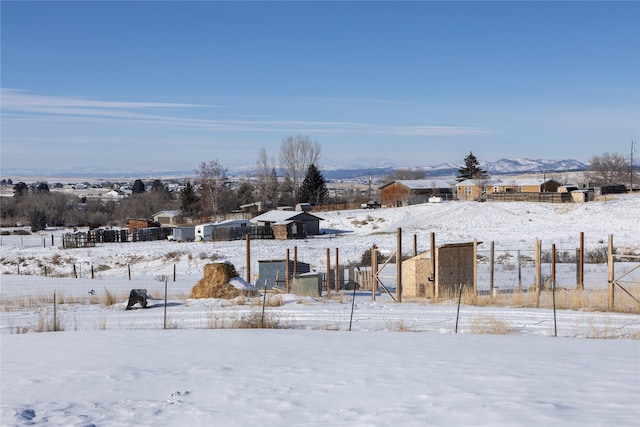 snowy yard with a mountain view