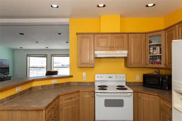 kitchen featuring kitchen peninsula and white appliances