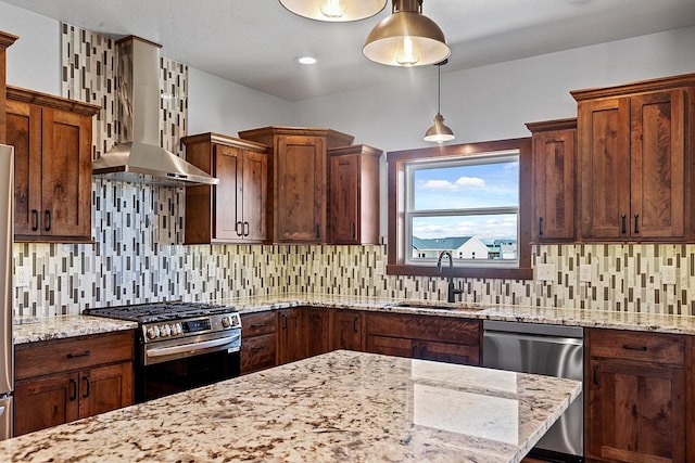 kitchen with a sink, stainless steel appliances, decorative backsplash, wall chimney exhaust hood, and light stone counters