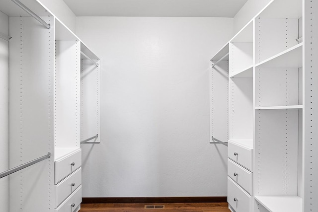 spacious closet with visible vents and dark wood-style floors