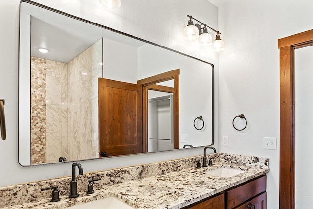 full bathroom with double vanity and a sink