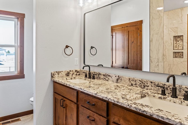 full bath with a sink, a healthy amount of sunlight, and visible vents