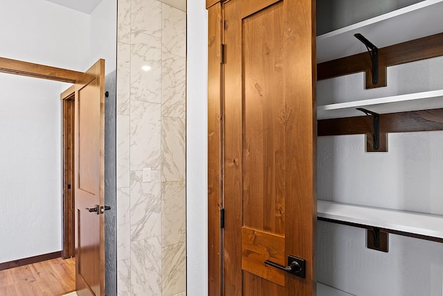 interior space featuring wood finished floors and baseboards
