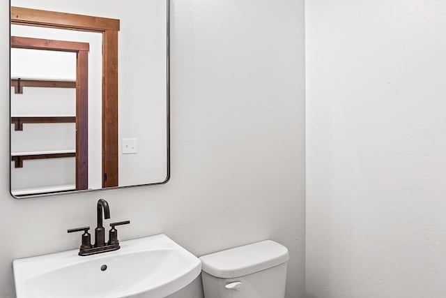 bathroom featuring toilet and a sink