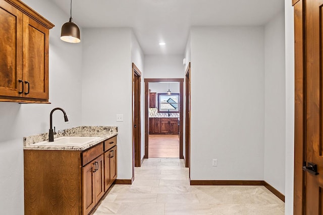 interior space with baseboards and a sink