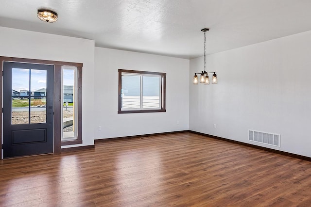 foyer with a chandelier, visible vents, dark wood finished floors, and baseboards