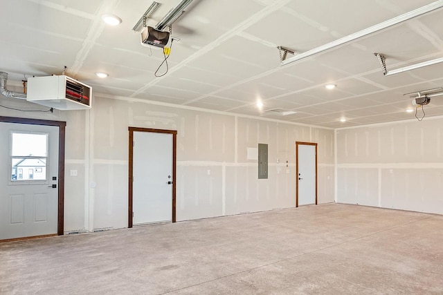 garage with electric panel, a garage door opener, and a heating unit