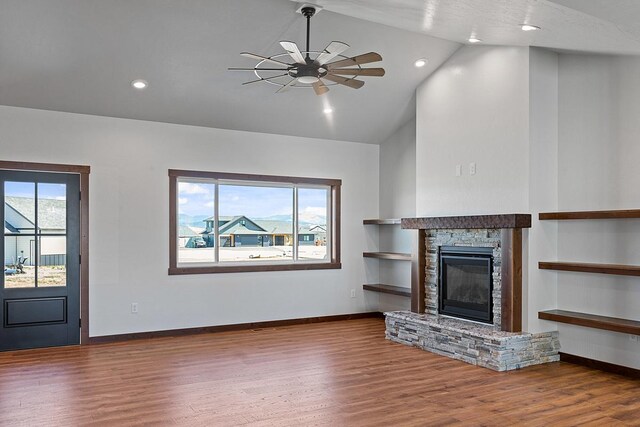 unfurnished living room with baseboards, high vaulted ceiling, wood finished floors, and ceiling fan