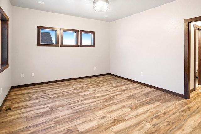 spare room with light wood-type flooring