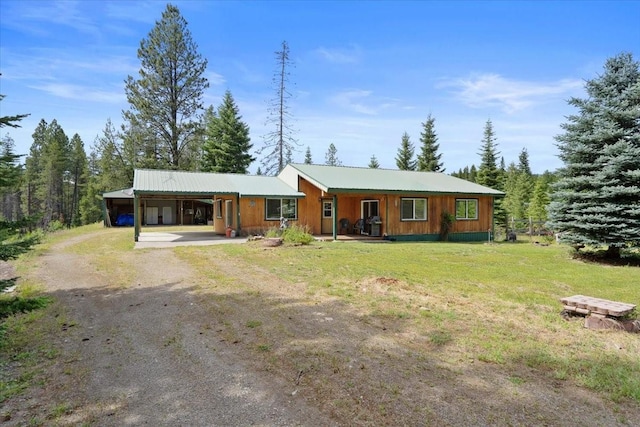 ranch-style house featuring a front yard and a carport