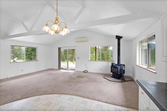 unfurnished living room with a wall unit AC, a wood stove, light colored carpet, a chandelier, and lofted ceiling with beams