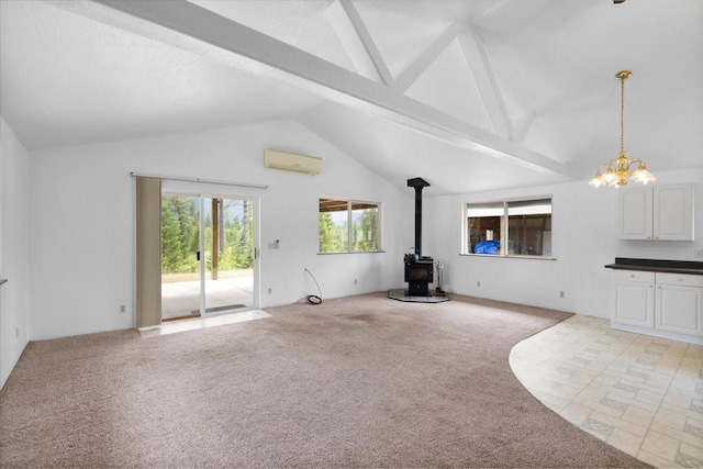 unfurnished living room featuring light carpet, a wood stove, a wall unit AC, high vaulted ceiling, and beam ceiling