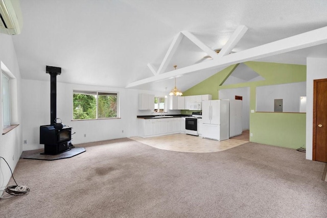 unfurnished living room with a wall unit AC, a wood stove, light colored carpet, electric panel, and beam ceiling