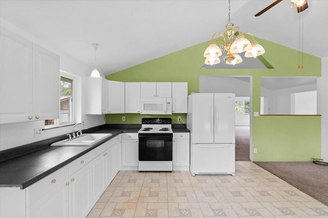 kitchen featuring decorative light fixtures, lofted ceiling, sink, white appliances, and white cabinetry