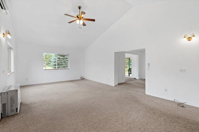 unfurnished living room with high vaulted ceiling, a wealth of natural light, and light carpet