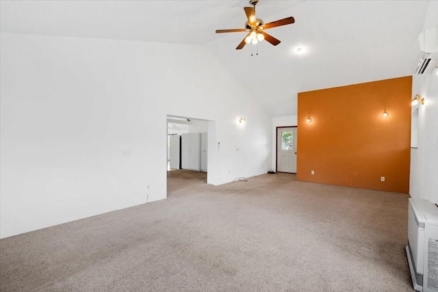 carpeted spare room featuring ceiling fan, a wall mounted AC, and high vaulted ceiling