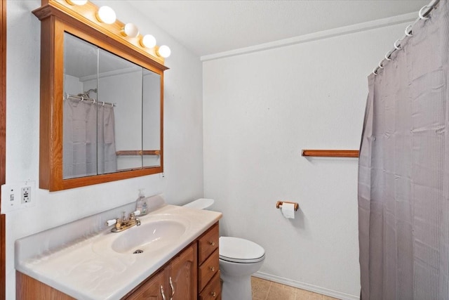 bathroom with toilet, vanity, and walk in shower