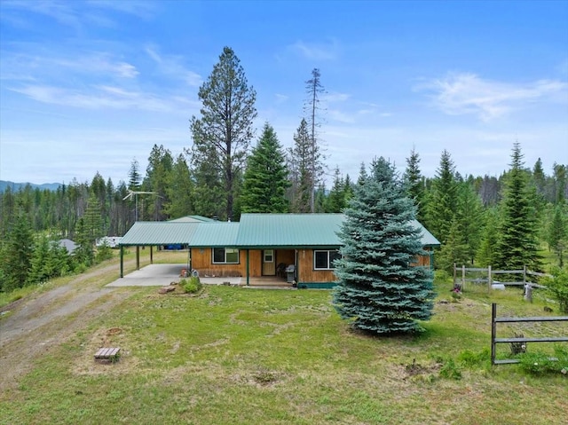 ranch-style home with a front lawn, a porch, and a carport