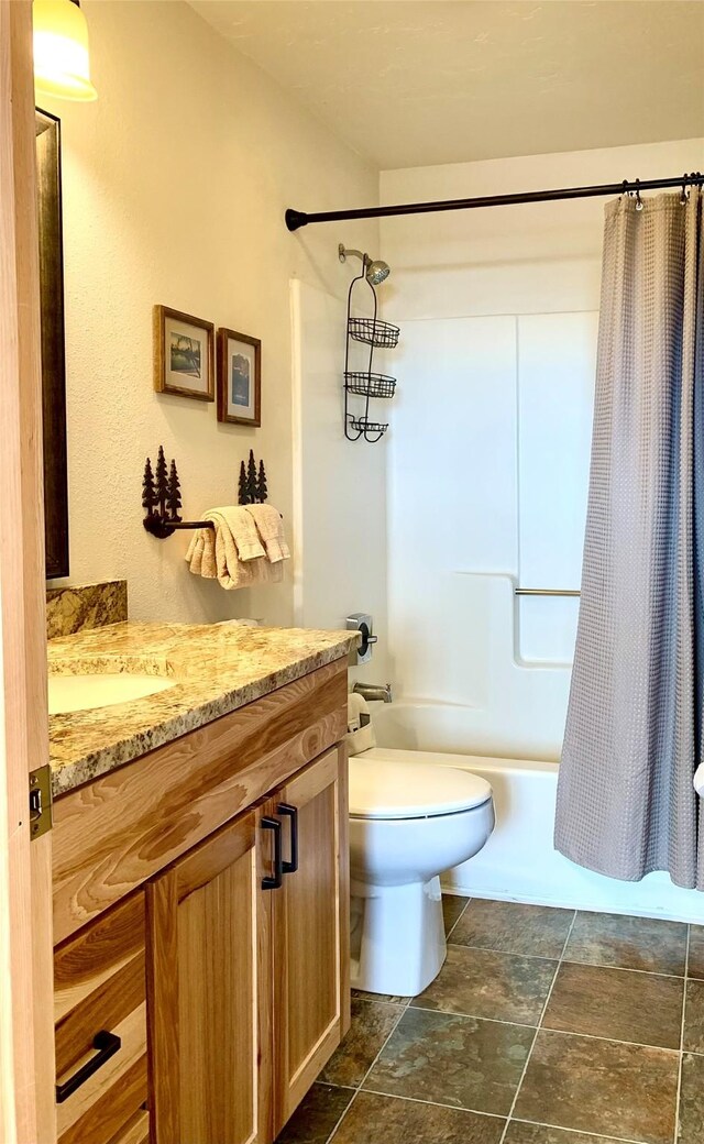 3898 Big Mountain Rd Unit 202, Whitefish, MT 59937 - full bathroom with vanity, shower / bath combo, and stone finish flooring