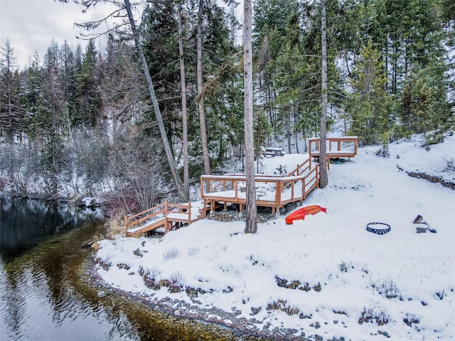 exterior space with a deck with water view