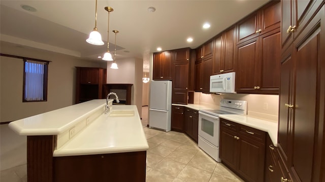 kitchen with pendant lighting, white appliances, sink, light tile patterned floors, and a center island with sink