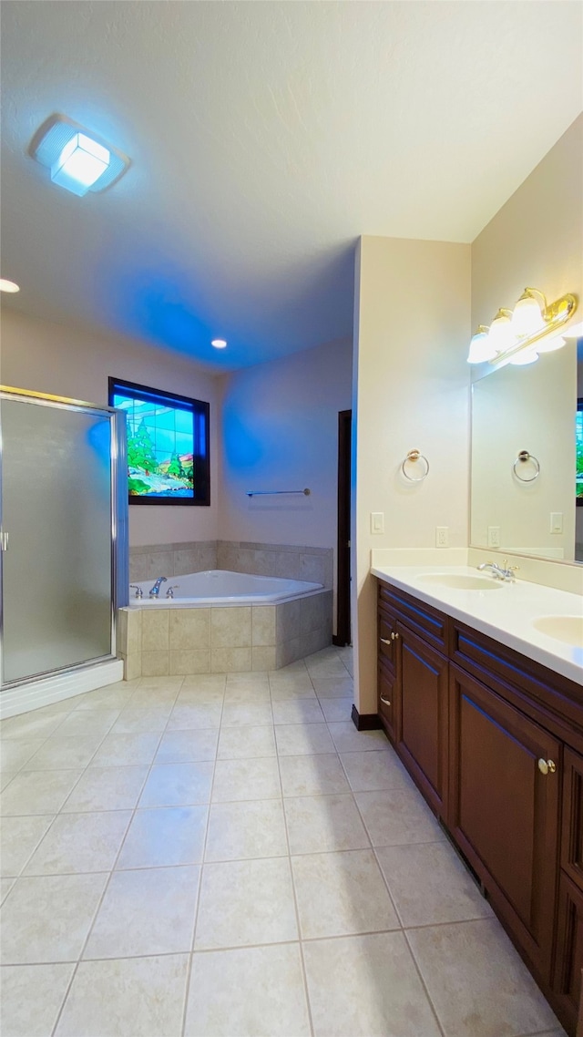 bathroom with tile patterned floors, vanity, and independent shower and bath