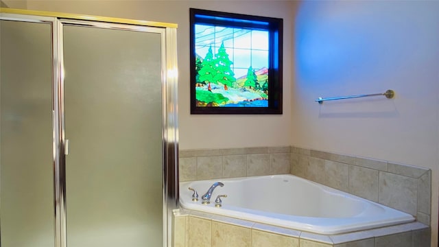 bathroom featuring shower with separate bathtub