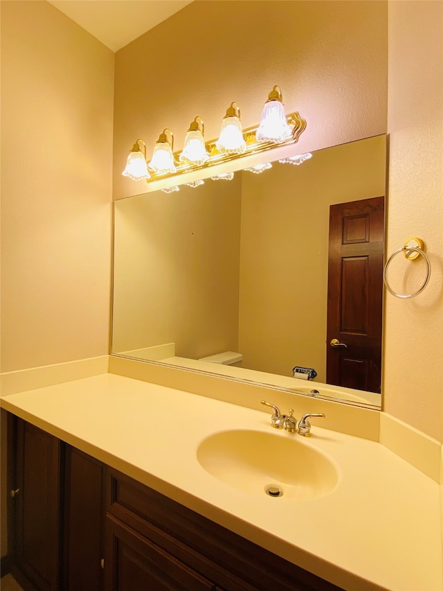 bathroom featuring toilet and vanity