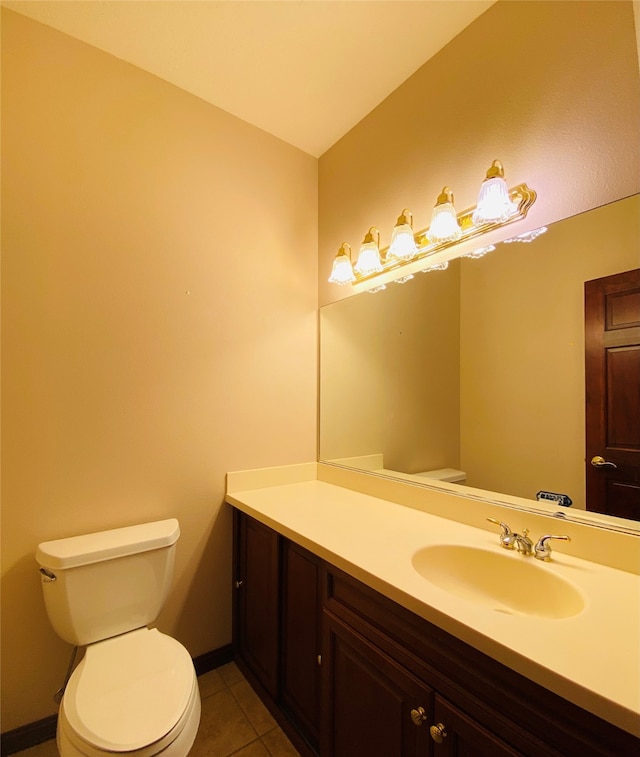 bathroom featuring toilet, vanity, and tile patterned flooring