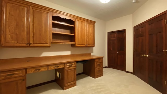 office area featuring light colored carpet and built in desk