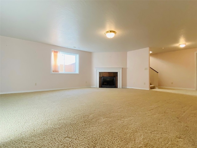 unfurnished living room with a tile fireplace