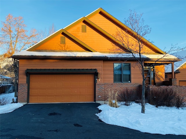 view of snowy exterior with a garage