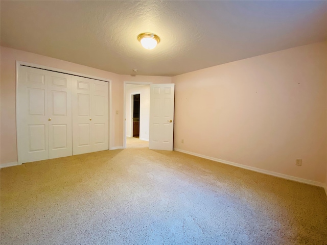 unfurnished bedroom featuring a closet and a textured ceiling