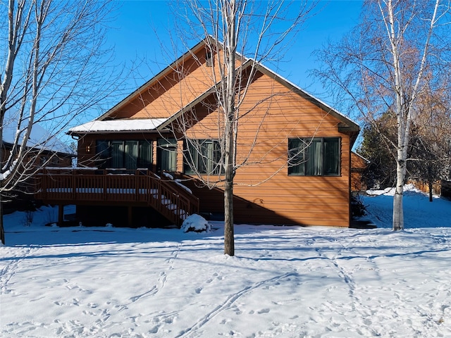 view of snow covered rear of property