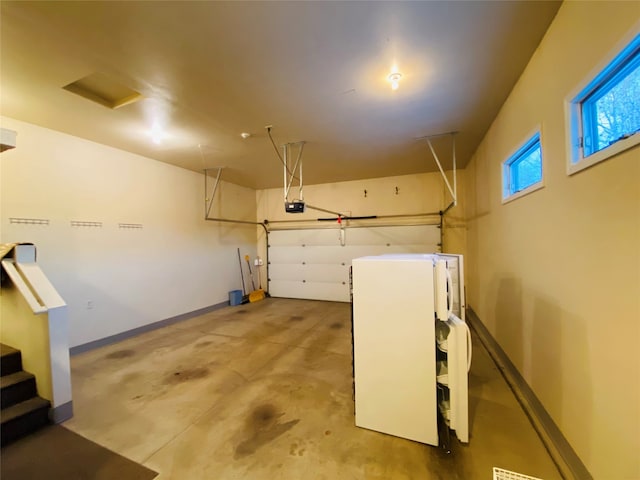 garage featuring a garage door opener and white fridge