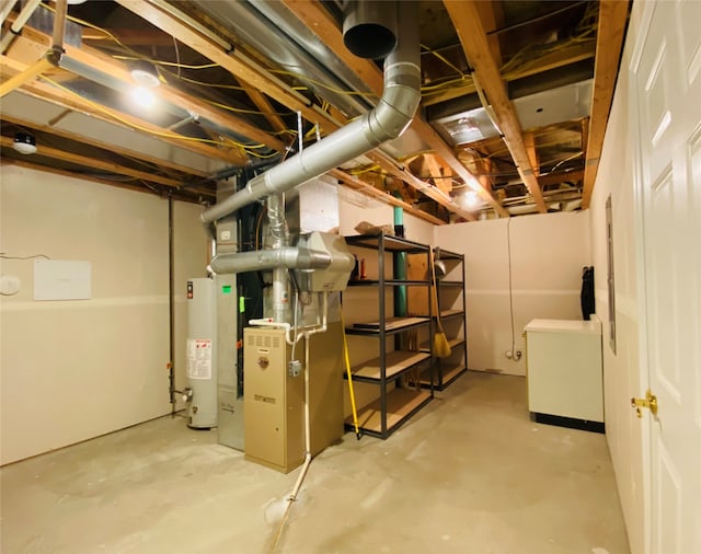 basement featuring fridge, heating unit, and gas water heater